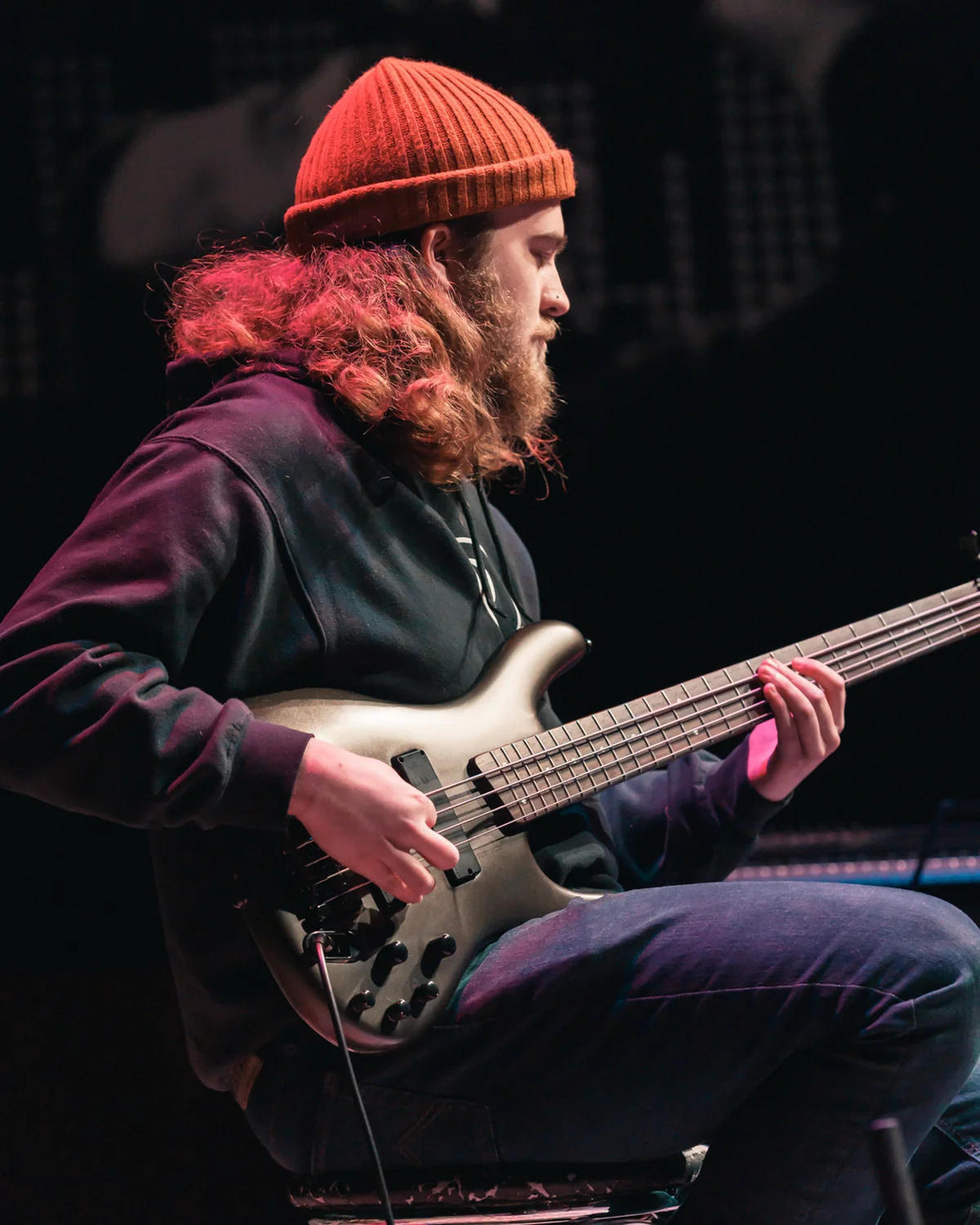 Bassist playing a six-string bass during a performance at Resonate in Edmonton