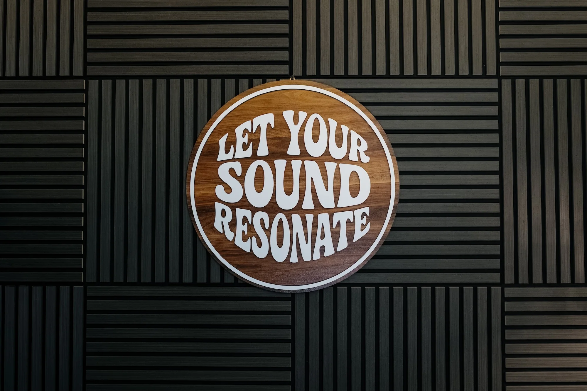 Let your sound resonate sign on Resonate acoustic wall