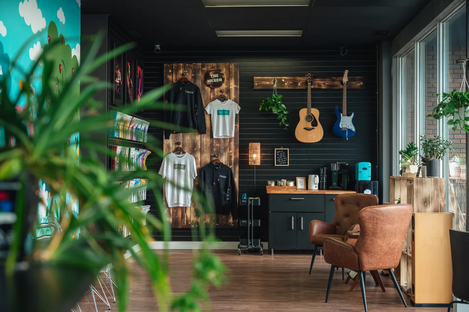The Resonate merch wall and coffee station with lounge chairs