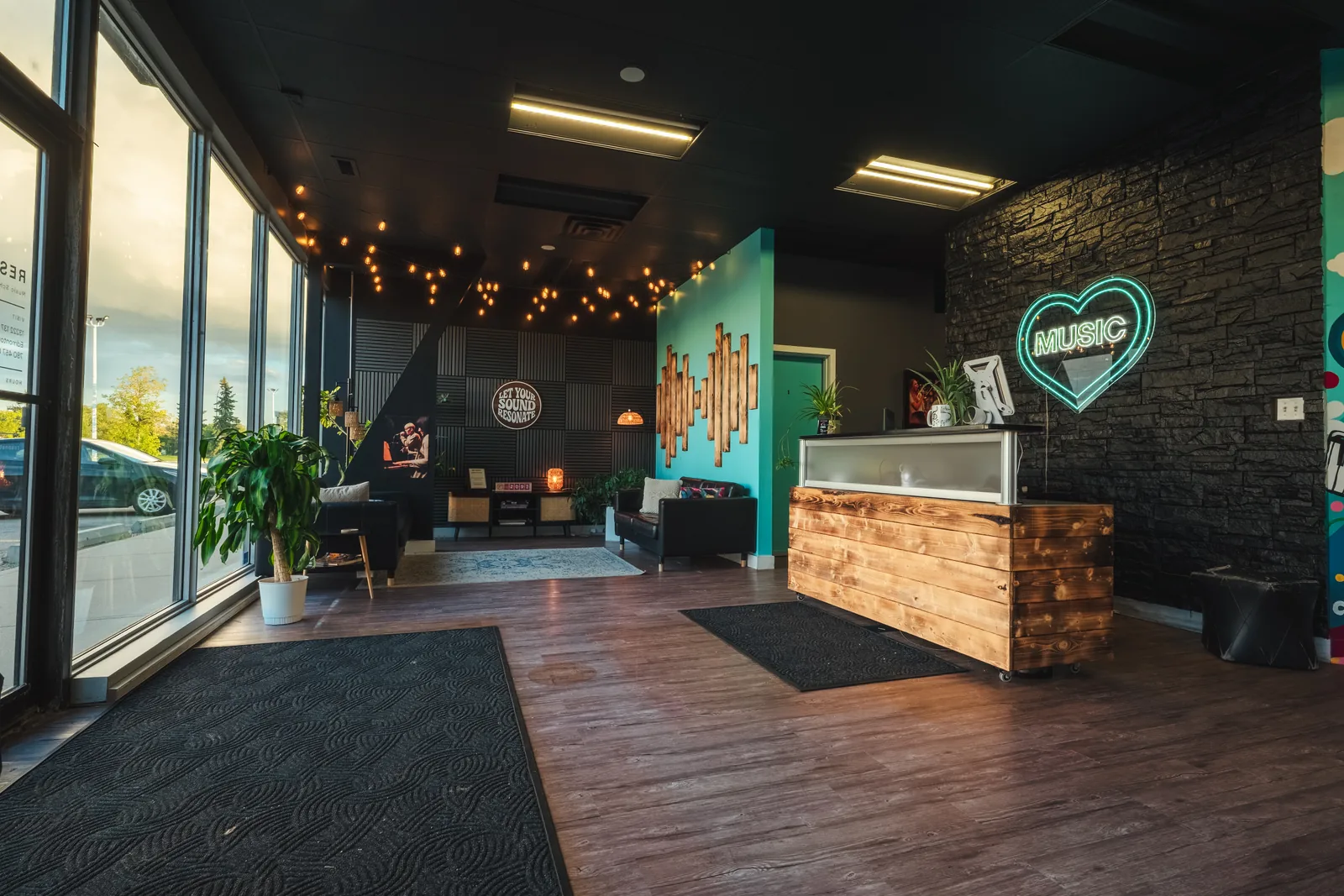 The Resonate reception desk with its neon heart and warm string lights