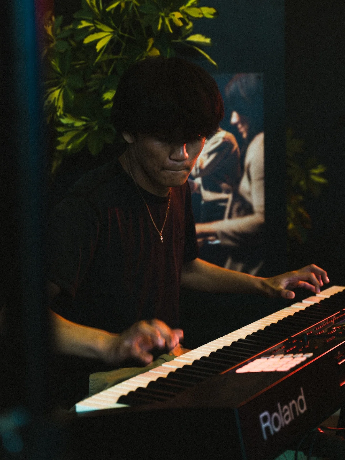 Mature player seated at the keyboard during a piano lesson at Resonate