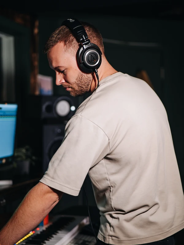 Conor "Conch" Wharton in headphones at the MIDI keyboard at Resonate Music Studio