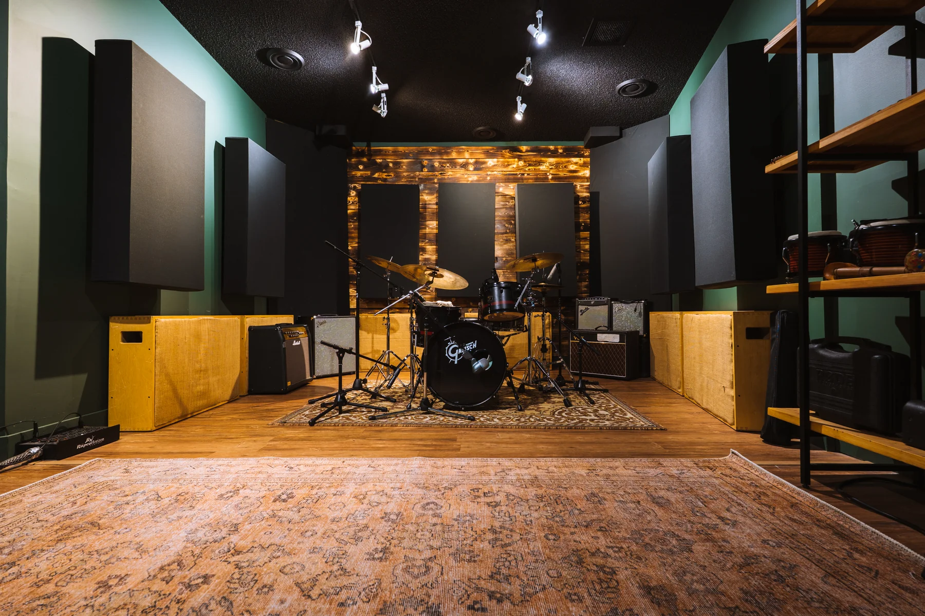 The Resonate live room with drum kit, acoustic treatment panels, and angled walls
