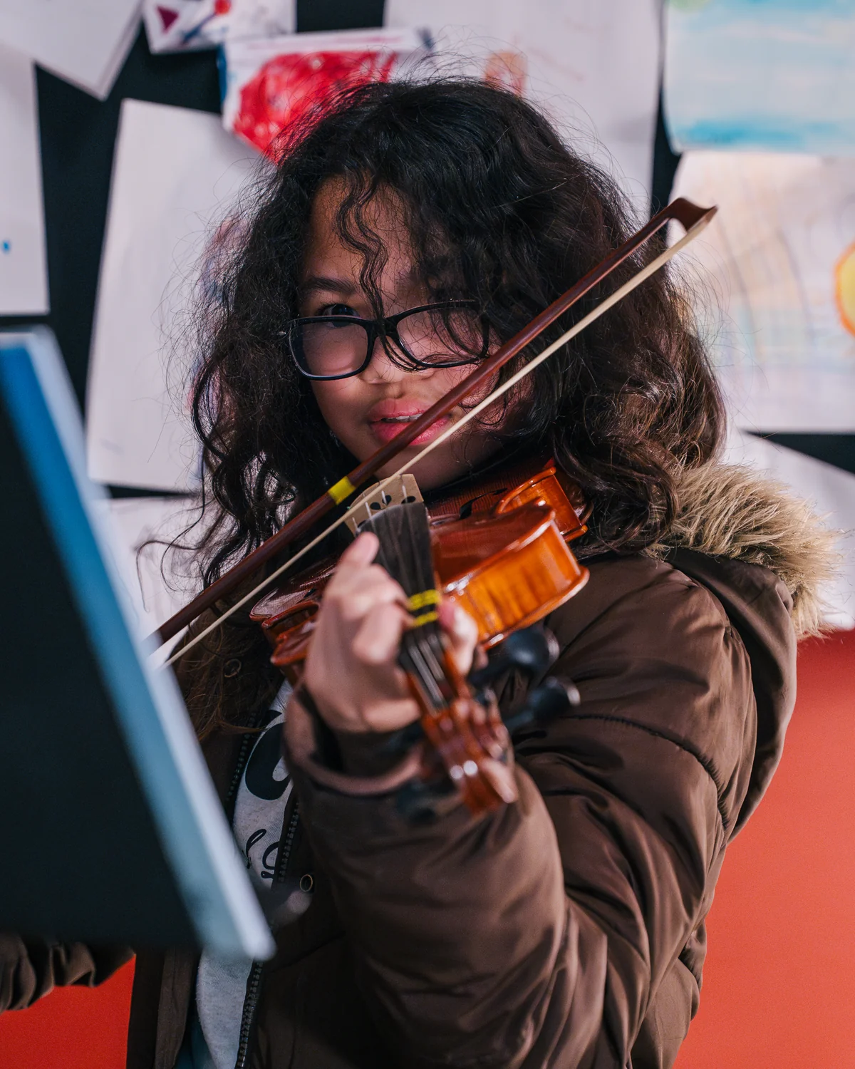 Young violin student in a Resonate lesson room in Edmonton